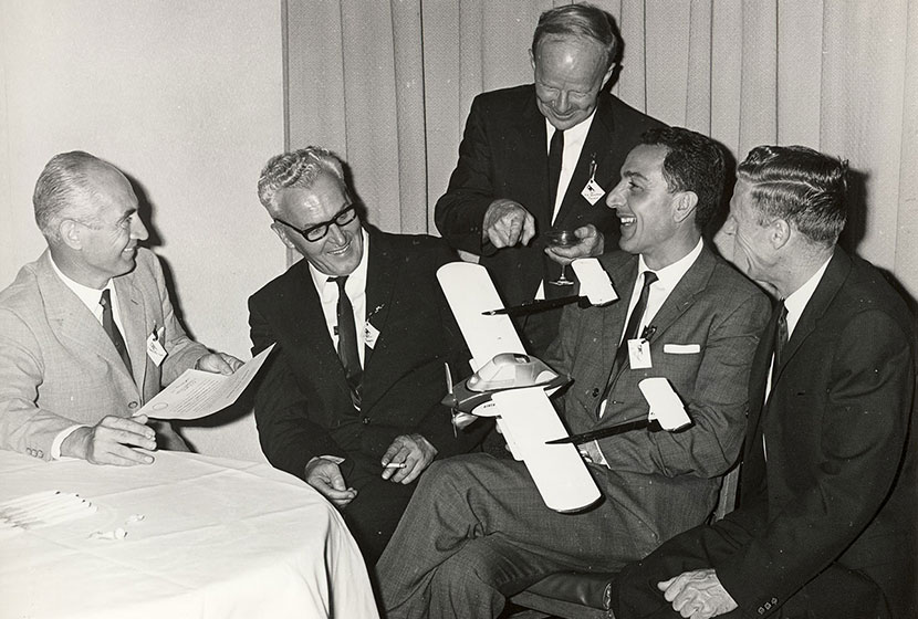 Early 1960s. Franco, Carlo and designer Luigi Pellarini examine a model of the Airtruk.