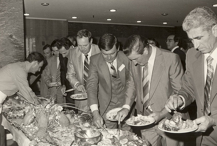Transfielders selecting their meal from a seafood banquet at Transfield's 25th anniversary dinner.