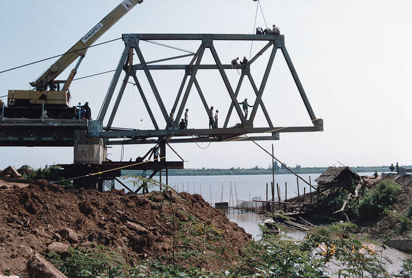 Construction begins on a steel truss bridge in Cambodia.