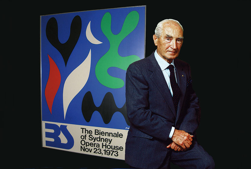 1973. Franco in front of the first Biennale of Sydney Poster designed by artist John Coburn.